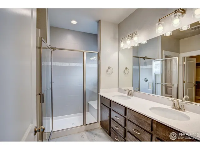 a bathroom with a double vanity sink mirror and double
