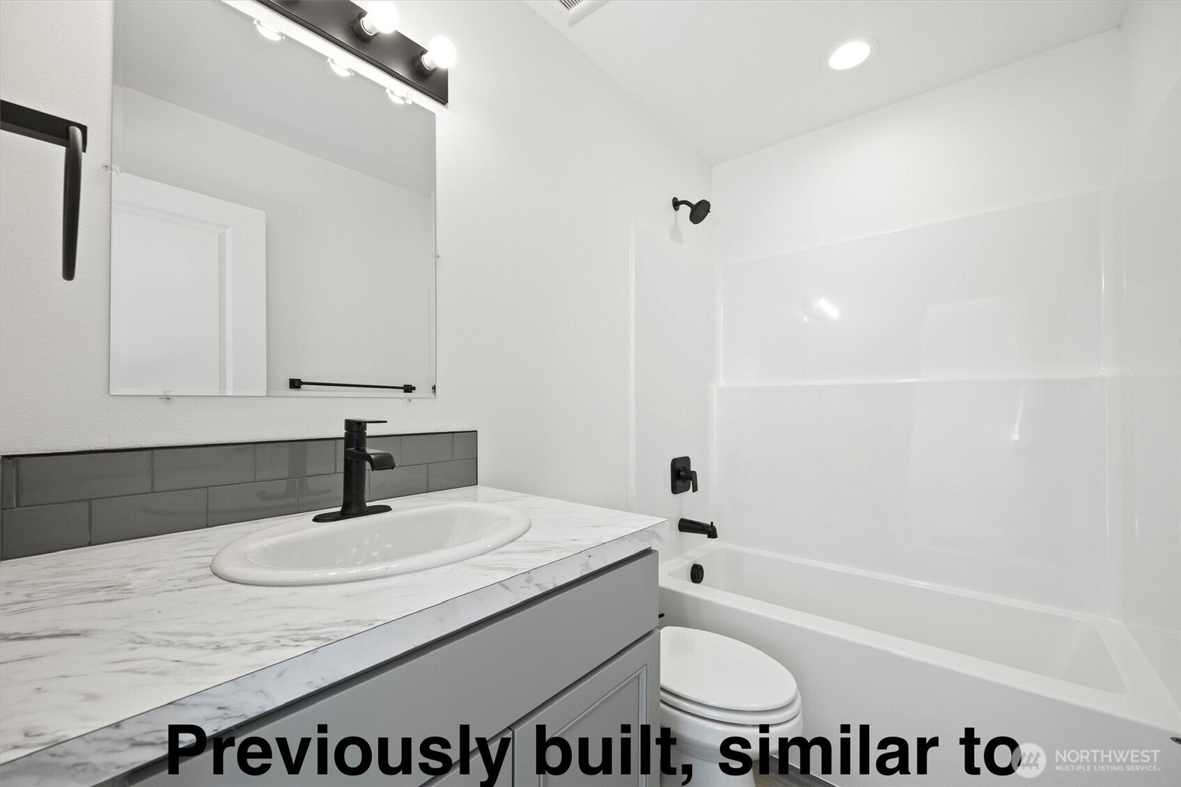108 North Ford Street Connell, WA 99326 - Photo 11 of 13 a bathroom with a granite countertop sink and a mirror