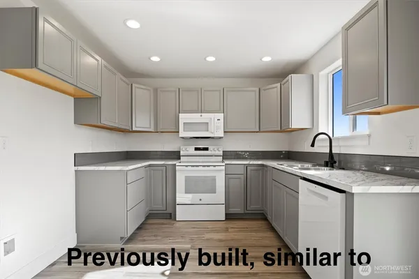a kitchen with a sink stainless steel appliances and cabinets