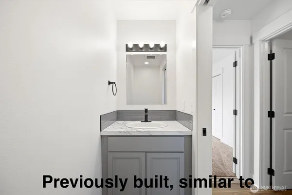 a bathroom with a sink vanity and a mirror