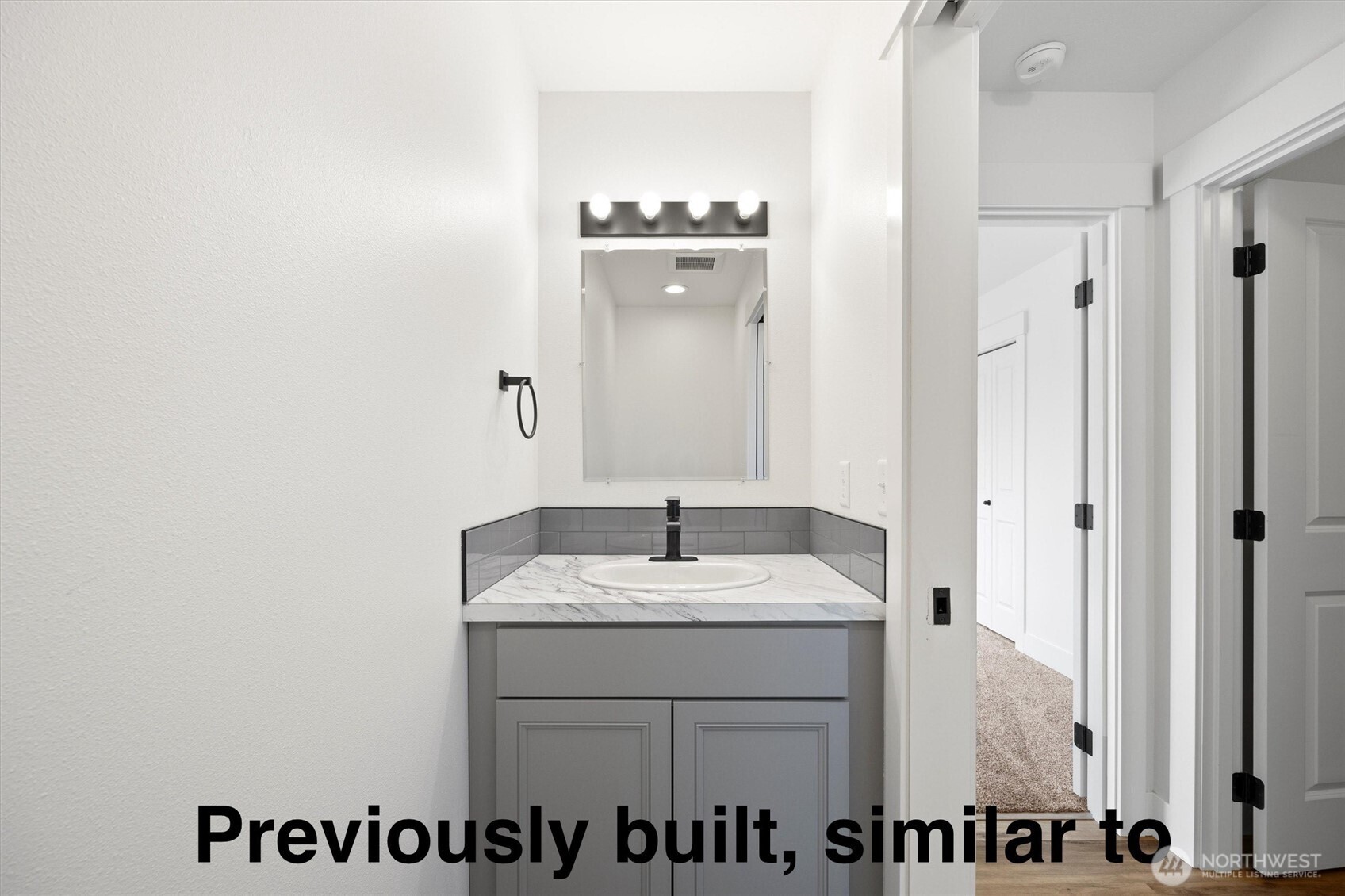 108 North Ford Street Connell, WA 99326 - Photo 8 of 13 a bathroom with a sink vanity and a mirror