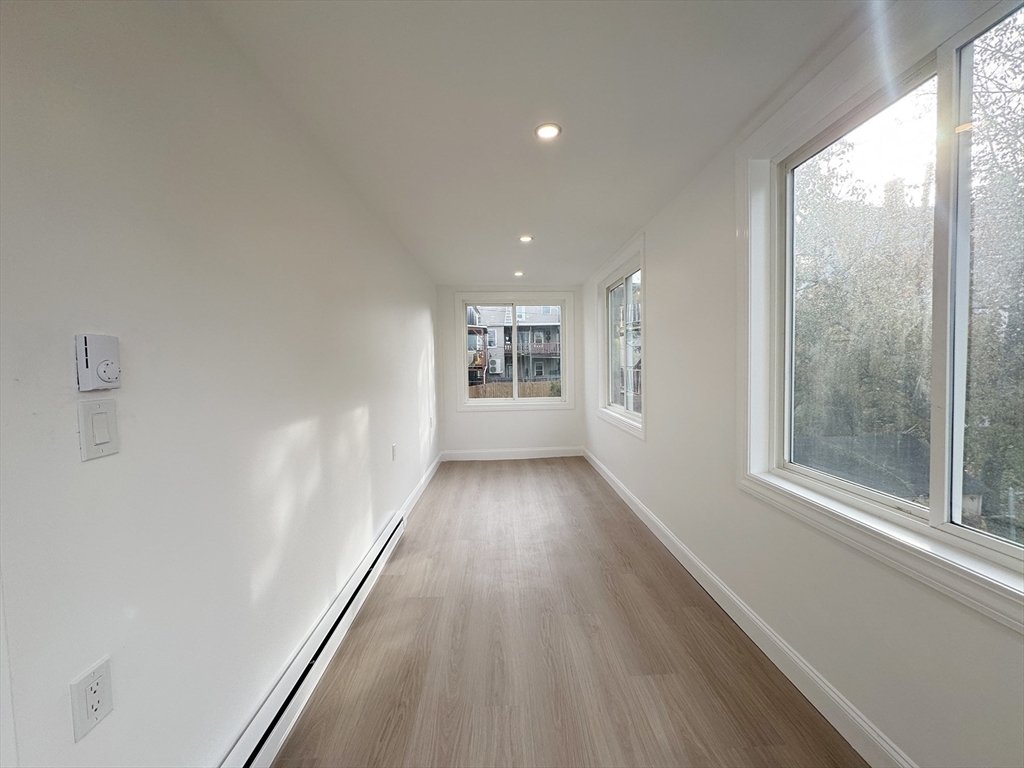 71 West Eagle Street, Unit 2 Boston, MA 02128 - Photo 13 of 31 a view of a big room with wooden floor and windows