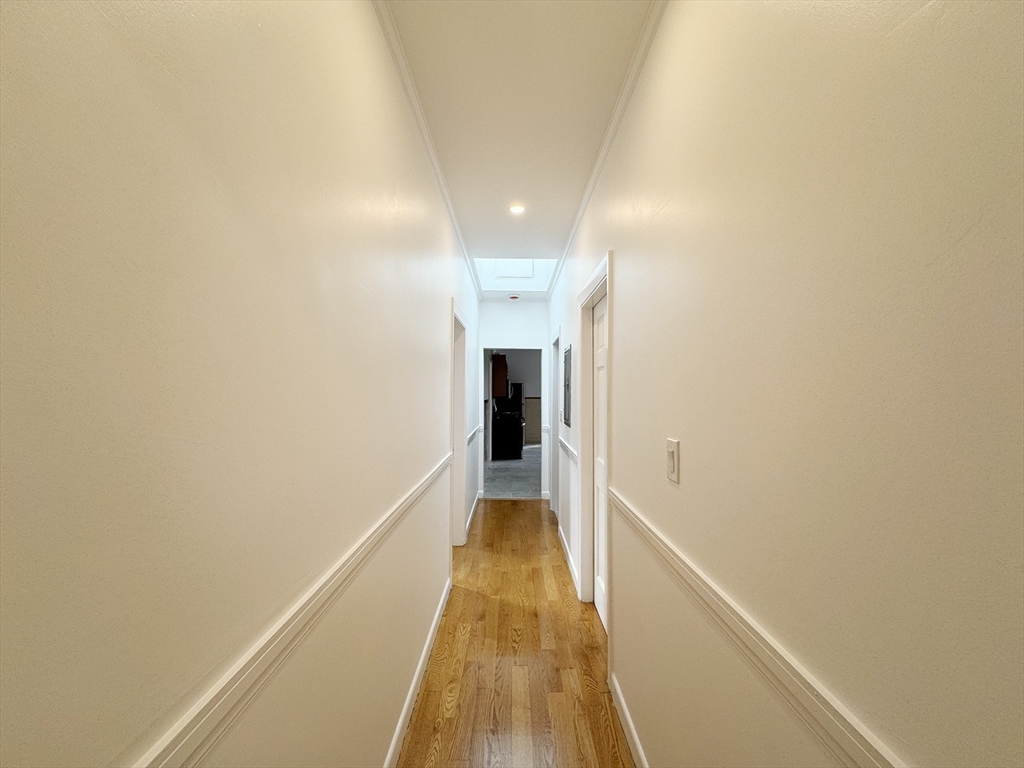 71 West Eagle Street, Unit 2 Boston, MA 02128 - Photo 17 of 31 a view of a hallway with wooden floor and staircase