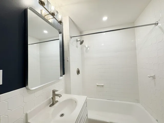 a bathroom with a shower and a sink