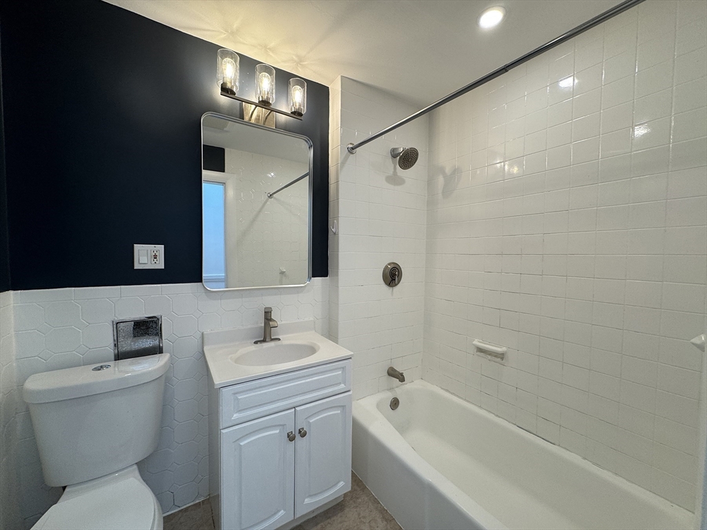71 West Eagle Street, Unit 2 Boston, MA 02128 - Photo 21 of 31 a bathroom with a sink toilet a shower and bathtub