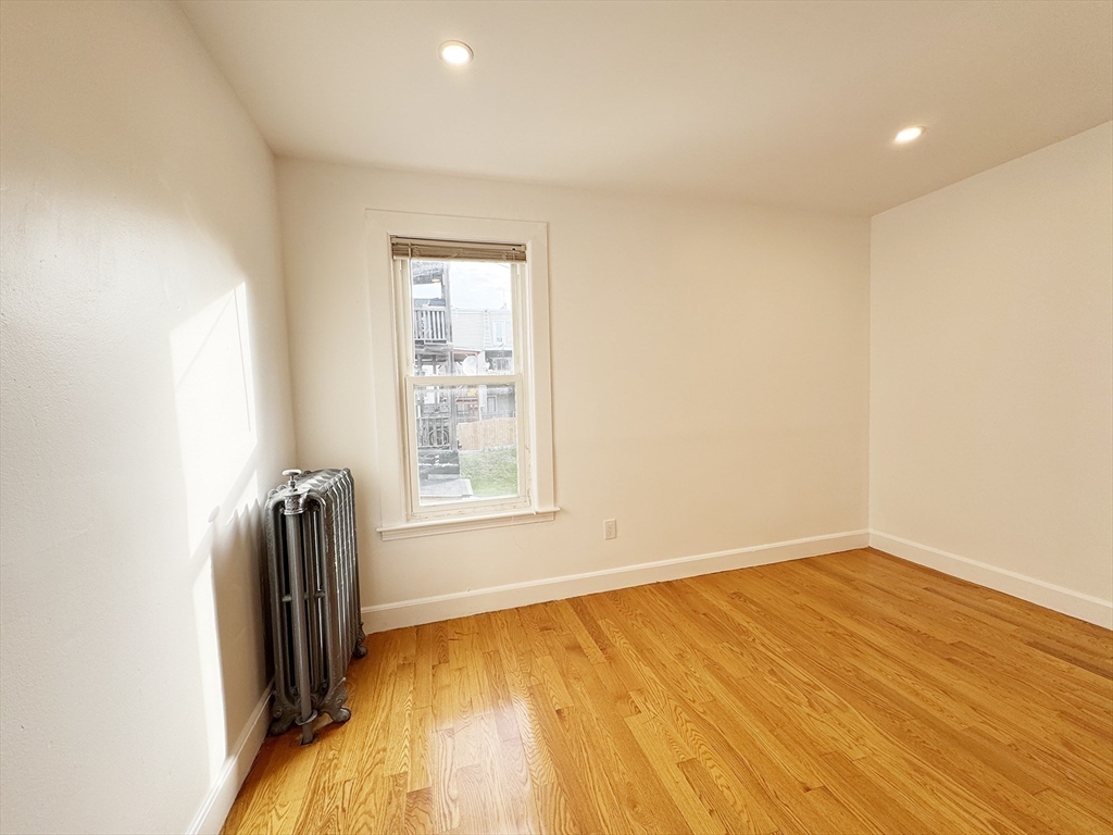 71 West Eagle Street, Unit 2 Boston, MA 02128 - Photo 23 of 31 an empty room with wooden floor and a window