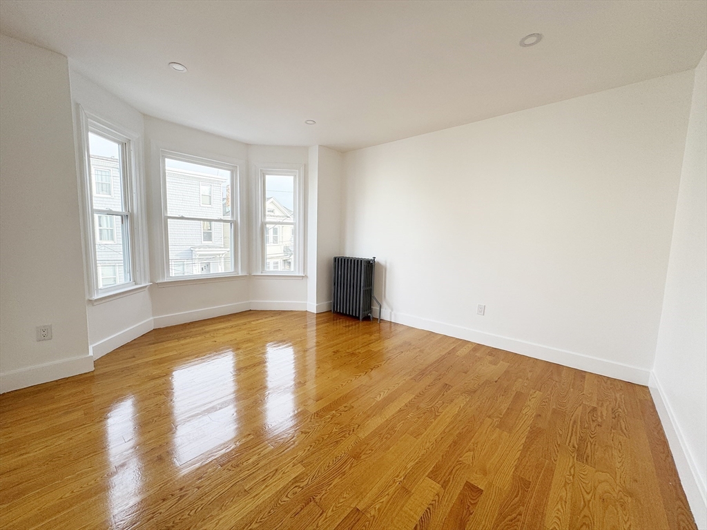 71 West Eagle Street, Unit 2 Boston, MA 02128 - Photo 4 of 31 a view of empty room with wooden floor and fan
