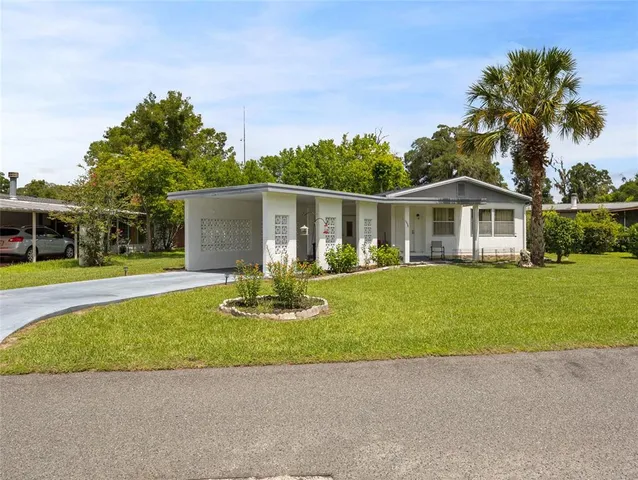 a front view of house with yard and green space