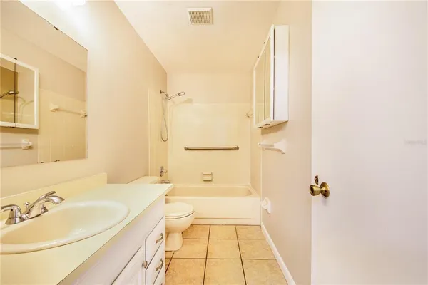 a bathroom with a tub sink and mirror