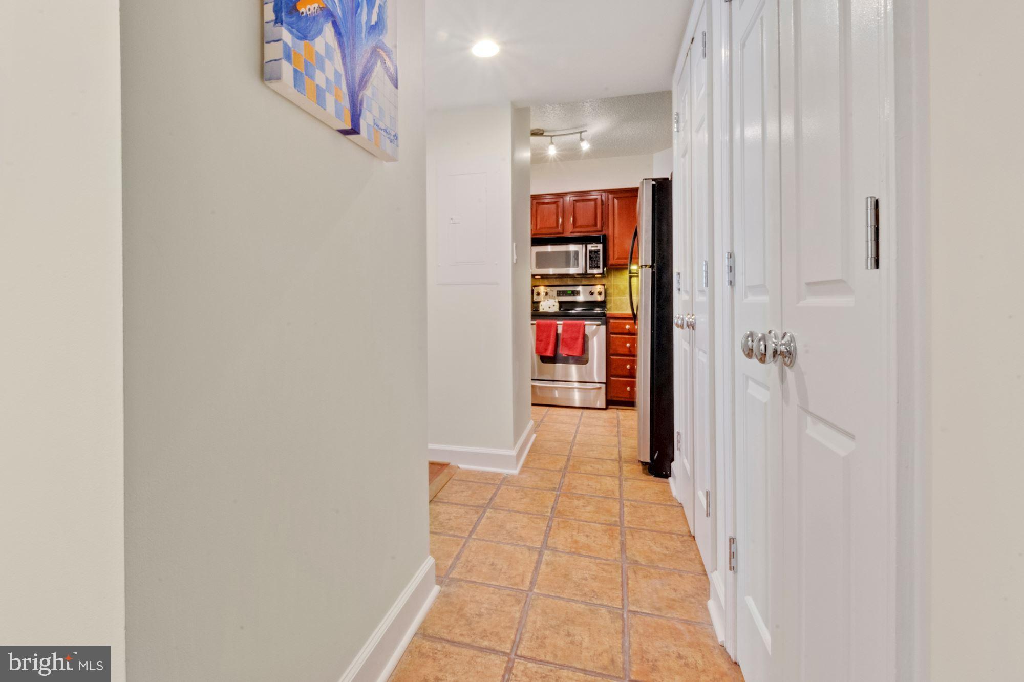 1080 Wisconsin Avenue Northwest, Unit 405 Washington, DC 20007 - Photo 12 of 31 a view of a hallway with closet and a window