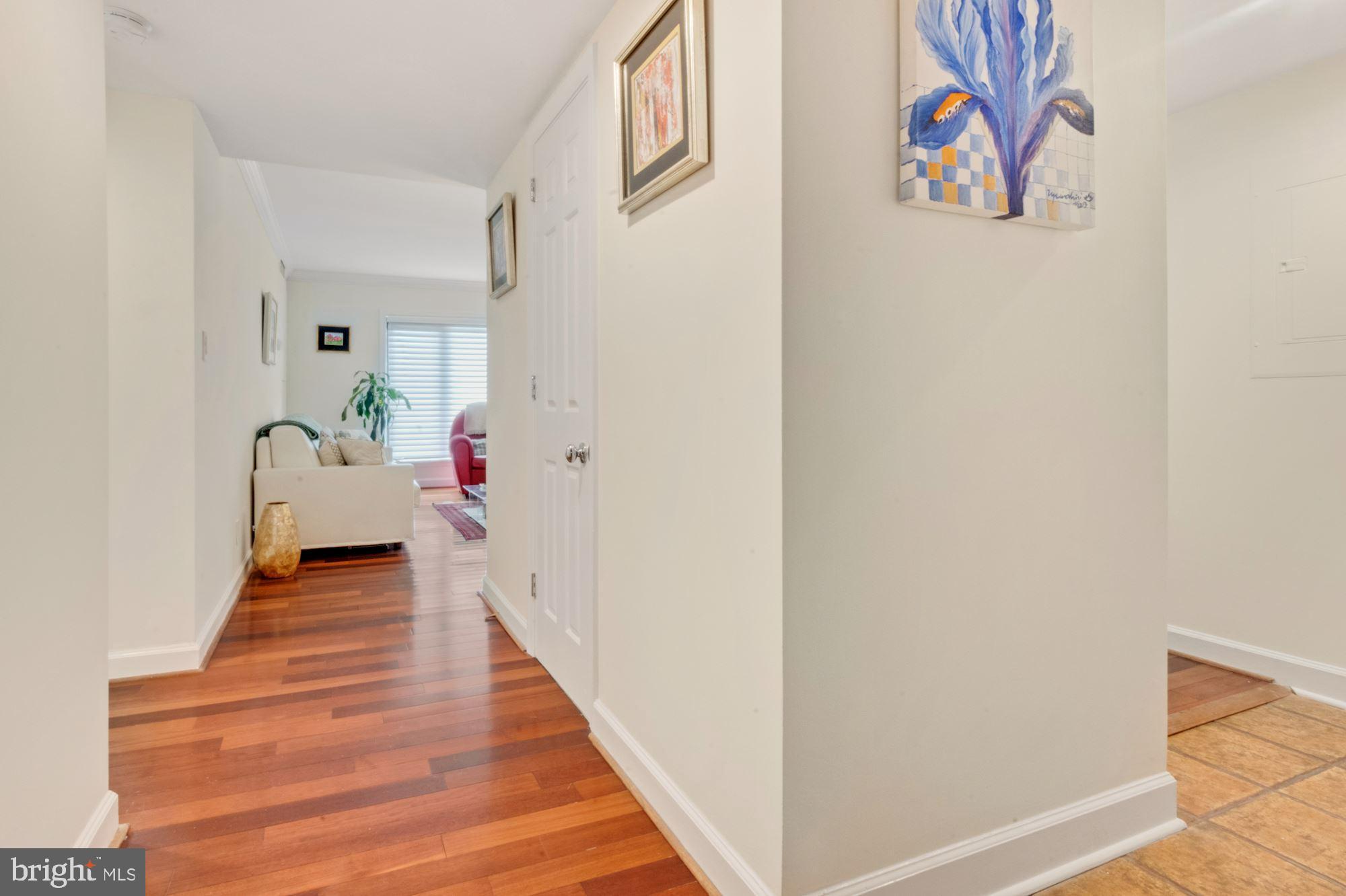 1080 Wisconsin Avenue Northwest, Unit 405 Washington, DC 20007 - Photo 17 of 31 a view of a hallway with wooden floor and closet