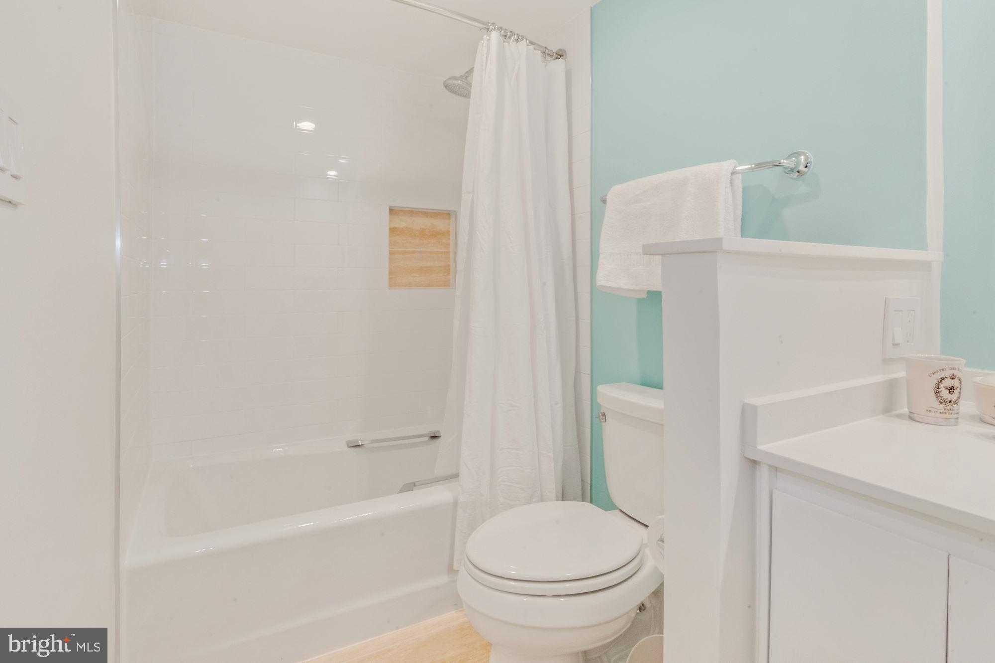 1080 Wisconsin Avenue Northwest, Unit 405 Washington, DC 20007 - Photo 24 of 31 a bathroom with a sink a toilet and shower