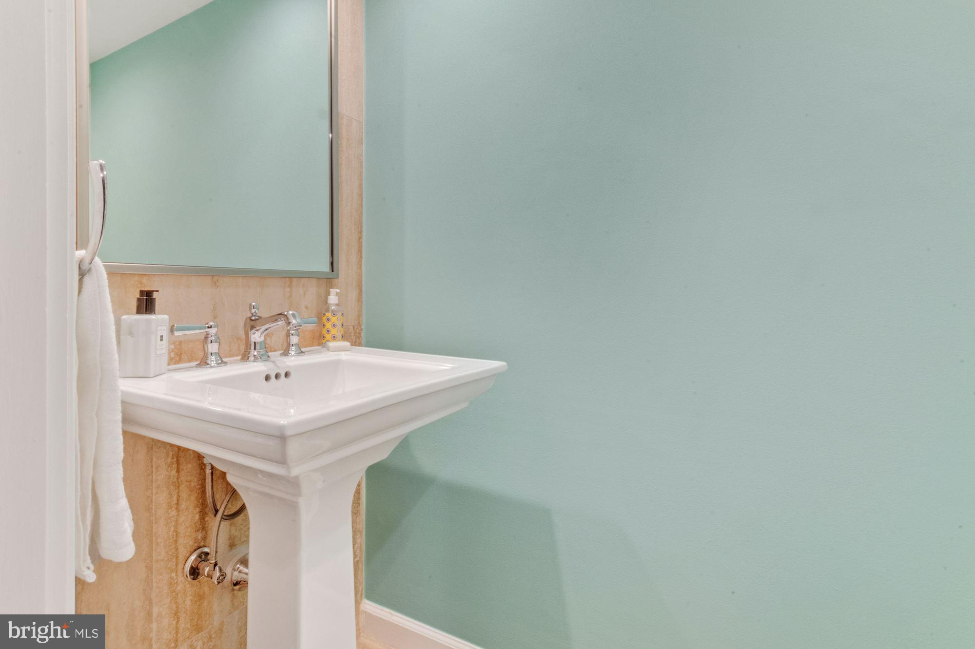 1080 Wisconsin Avenue Northwest, Unit 405 Washington, DC 20007 - Photo 25 of 31 a bathroom with a sink and a mirror