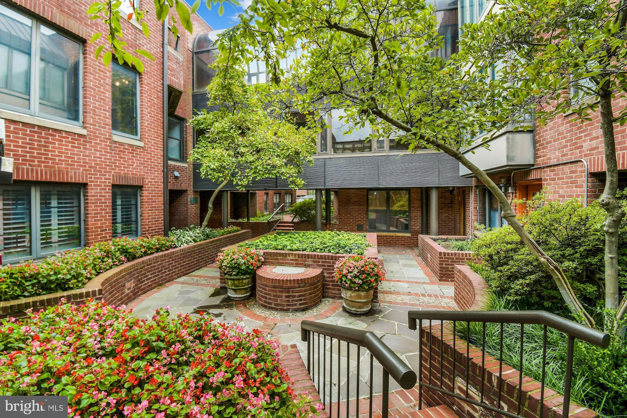 1080 Wisconsin Avenue Northwest, Unit 405 Washington, DC 20007 - Photo 29 of 31 a front view of a house with patio
