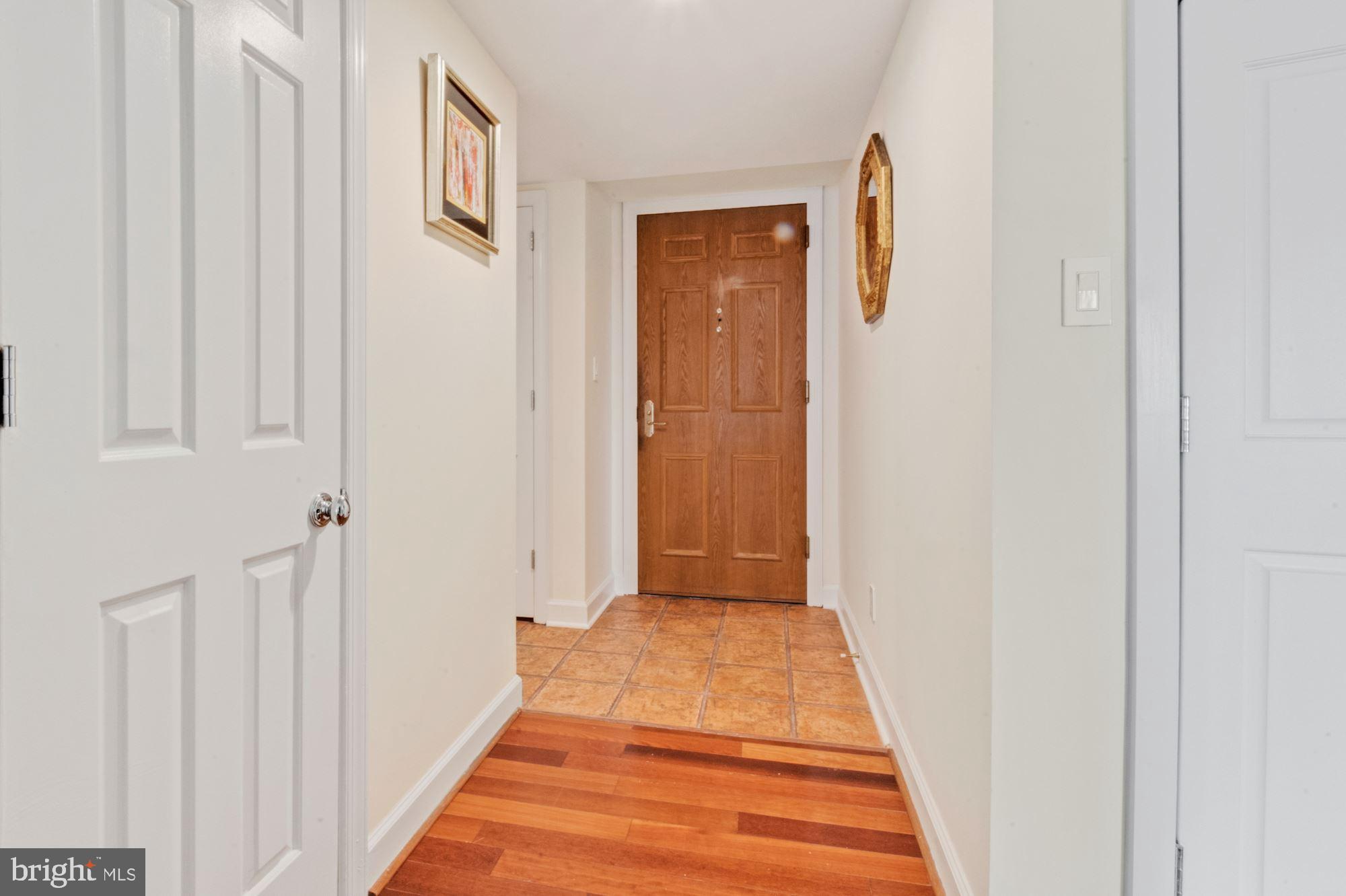 1080 Wisconsin Avenue Northwest, Unit 405 Washington, DC 20007 - Photo 5 of 31 a view of a hallway with wooden floor and entryway