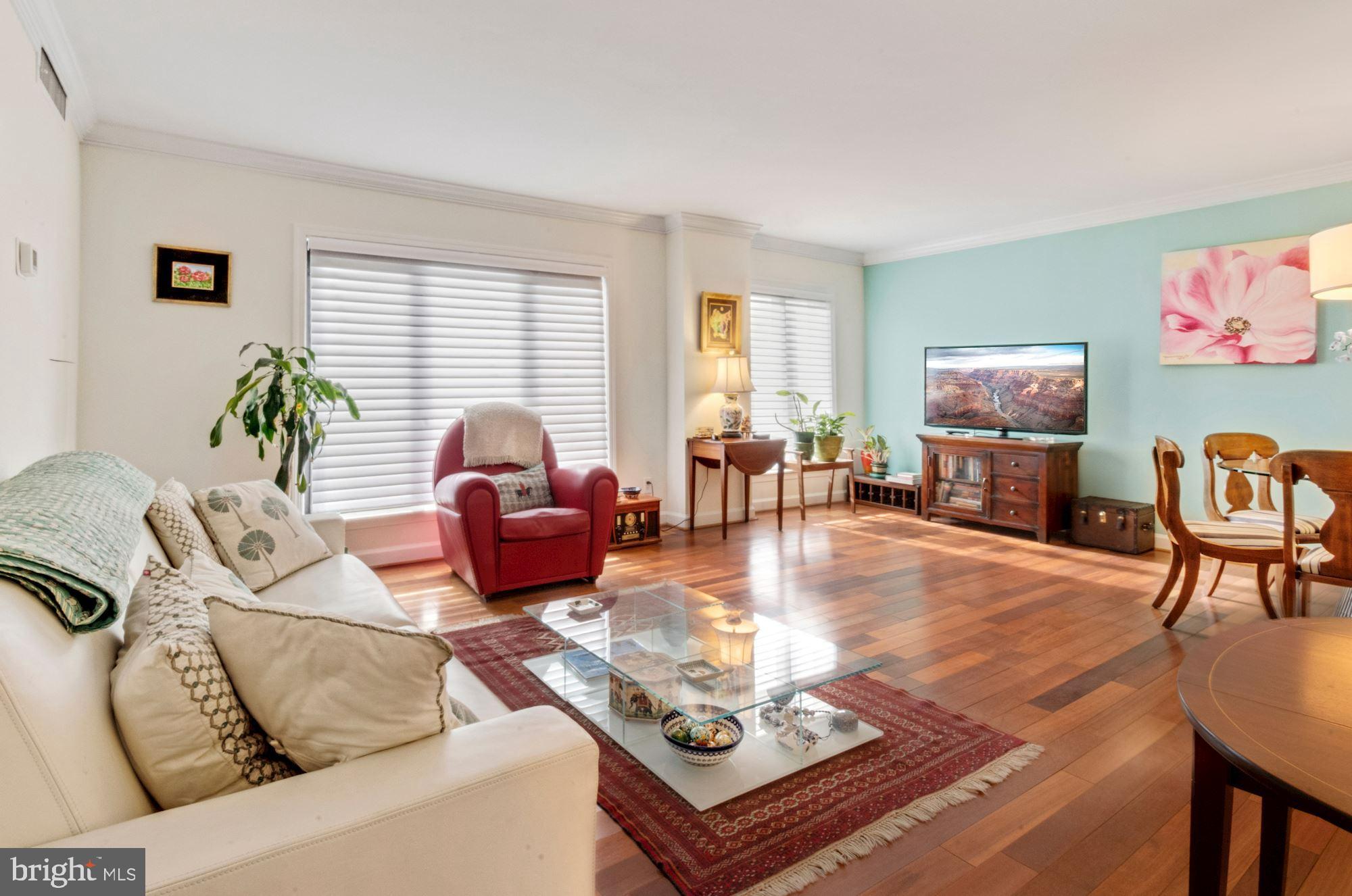 1080 Wisconsin Avenue Northwest, Unit 405 Washington, DC 20007 - Photo 6 of 31 a living room with furniture and wooden floor