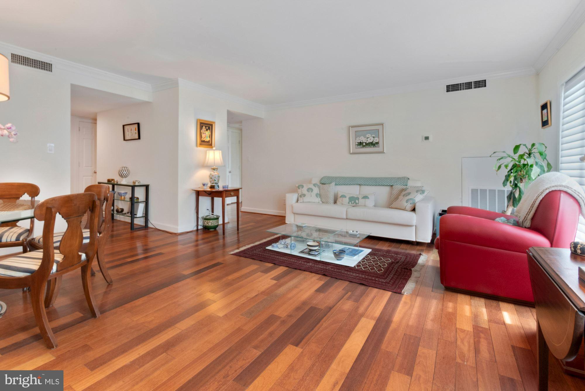 1080 Wisconsin Avenue Northwest, Unit 405 Washington, DC 20007 - Photo 9 of 31 a living room with furniture and wooden floor