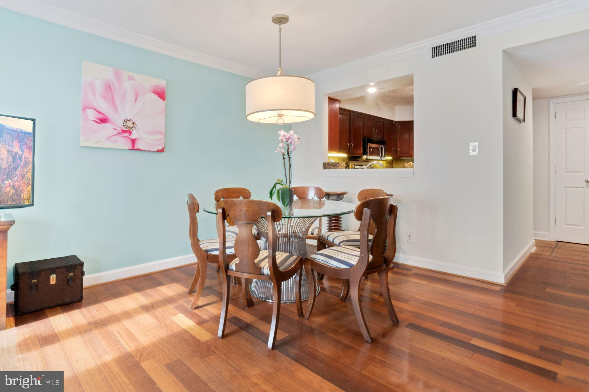 1080 Wisconsin Avenue Northwest, Unit 405 Washington, DC 20007 - Photo 10 of 31 a view of a dining room with furniture and wooden floor