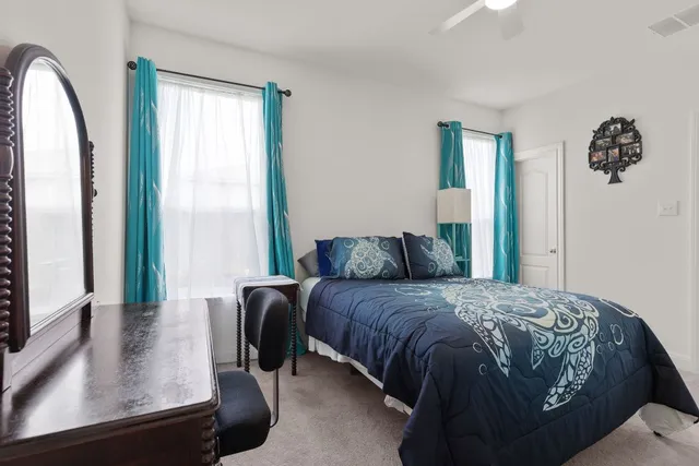 a bedroom with a large bed and a flat screen tv