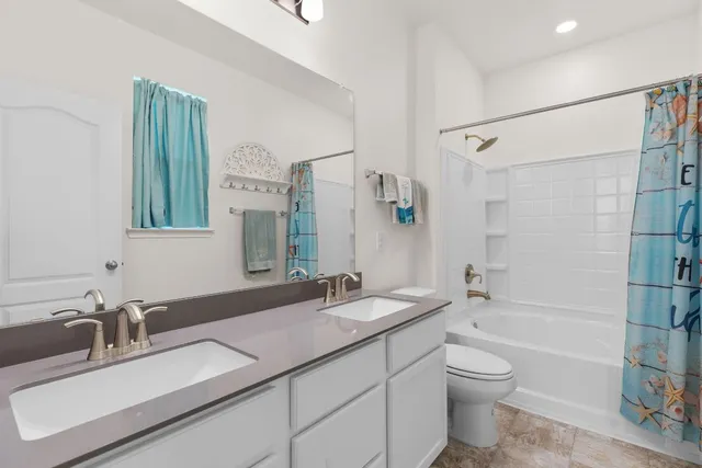 a bedroom with a bed lamp and a large window