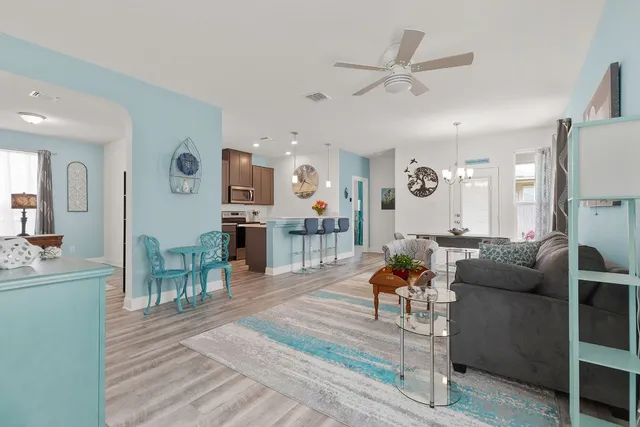 a living room with furniture and wooden floor