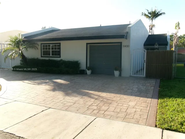 a view of backyard with potted plants and a bench