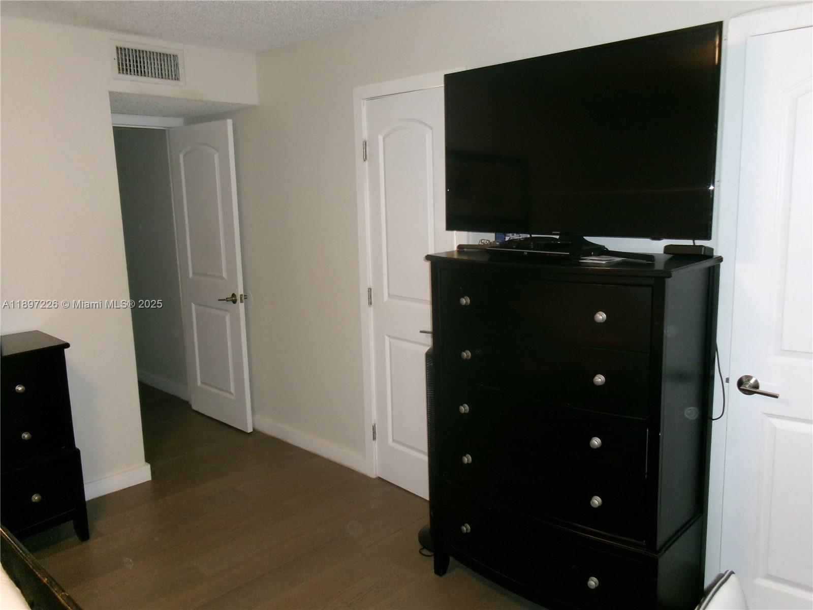 11430 Southwest 83rd Terrace Miami, FL 33173 - Photo 11 of 19 wooden floor and television