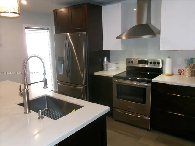 a kitchen with a sink and a stove top oven