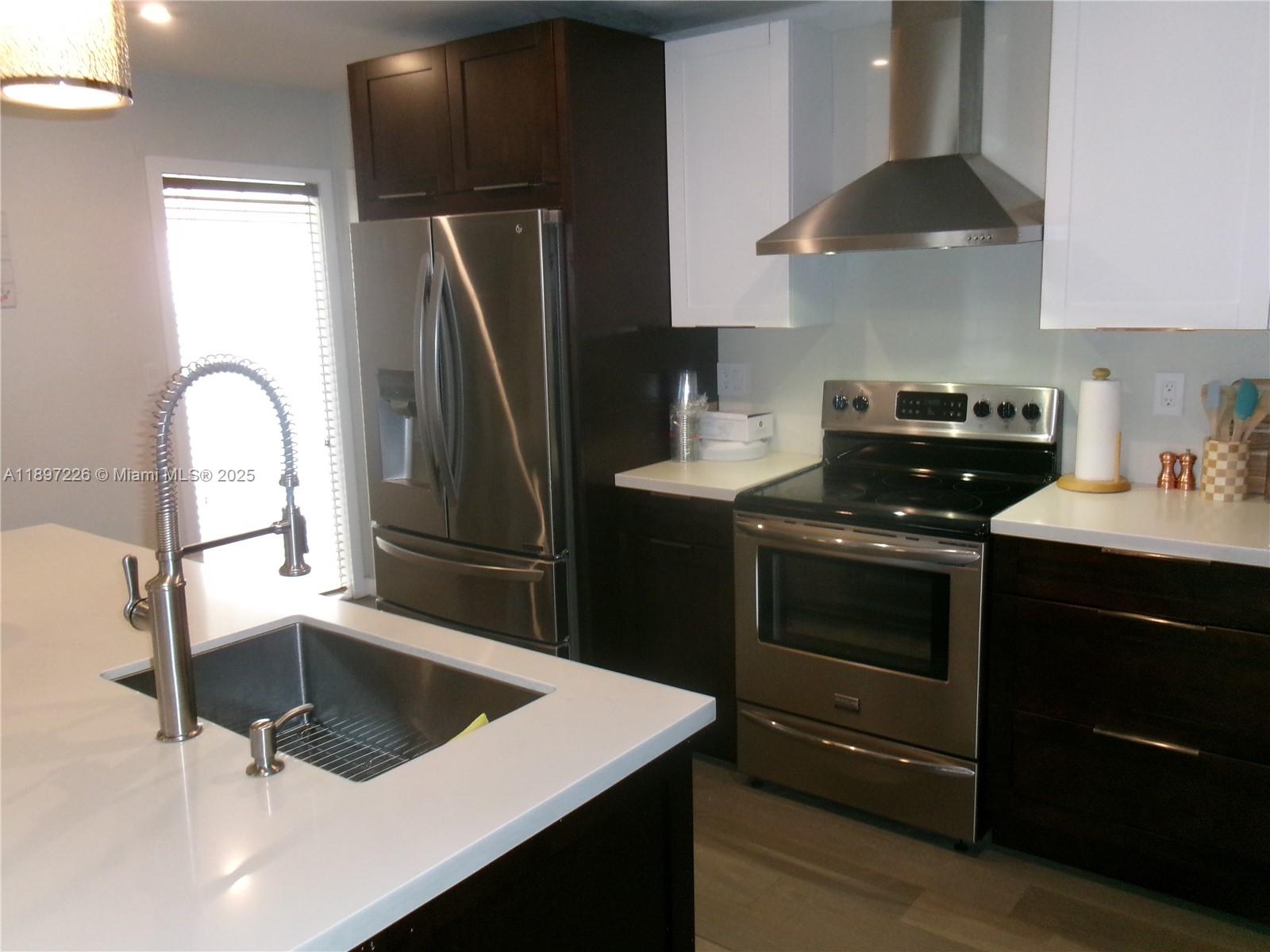 11430 Southwest 83rd Terrace Miami, FL 33173 - Photo 8 of 19 a kitchen with a sink and a stove top oven