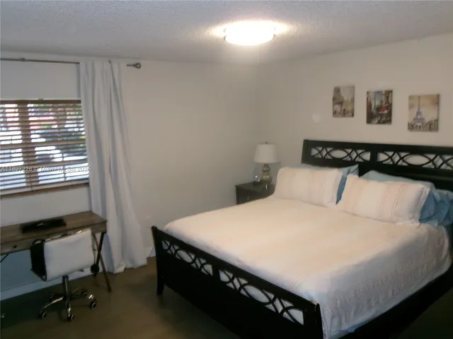 a bedroom with a bed and a desk