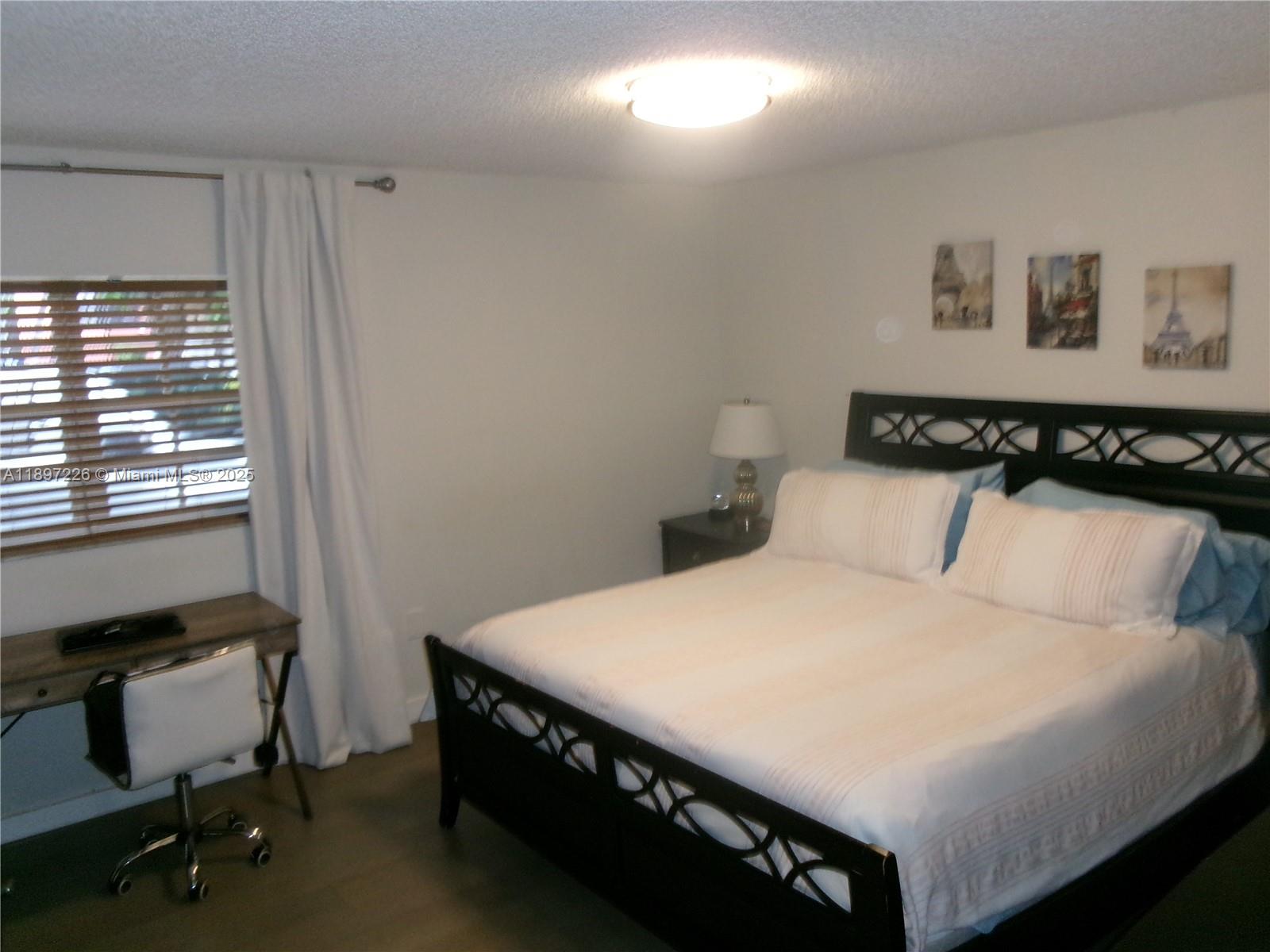 11430 Southwest 83rd Terrace Miami, FL 33173 - Photo 9 of 19 a bedroom with a bed and a desk