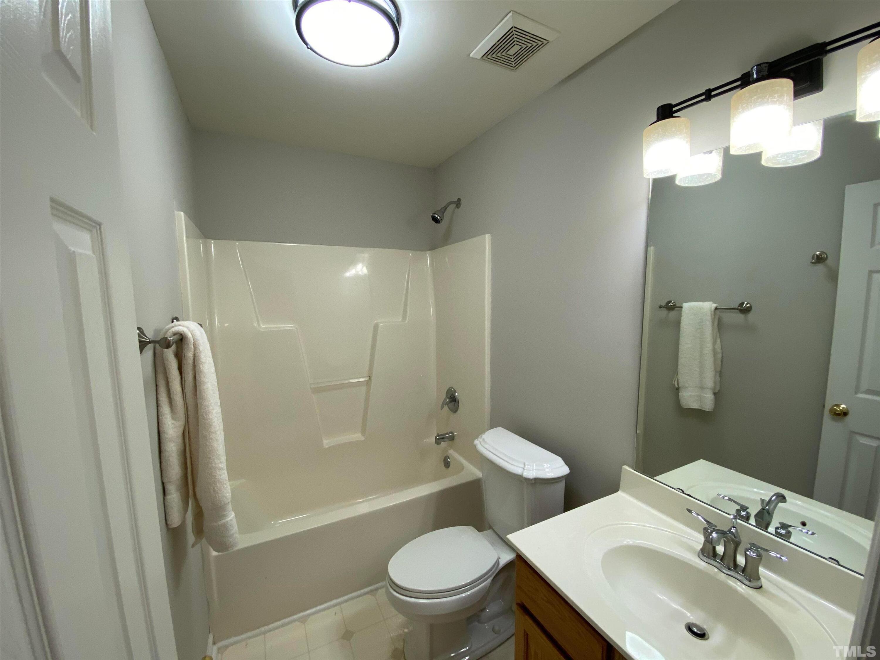 2413 Wellington Ridge Loop, Unit 2413 Cary, NC 27518 - Photo 16 of 30 a bathroom with a sink toilet and shower