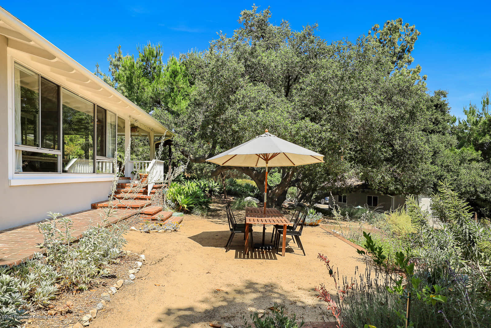 1955 Windover Road Pasadena, CA 91107 - Photo 50 of 71 a view of a patio with a table and chairs under an umbrella