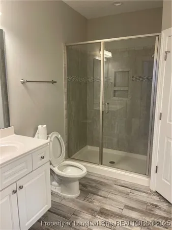 a bathroom with a toilet and a shower