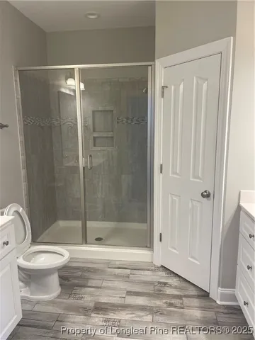 a bathroom with a shower a toilet and a sink