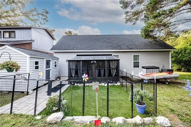 a view of a backyard with swimming pool