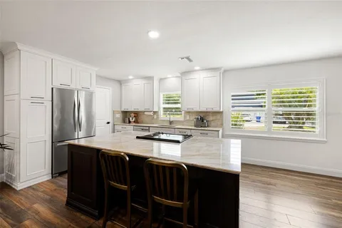 a kitchen with stainless steel appliances granite countertop a stove and a refrigerator