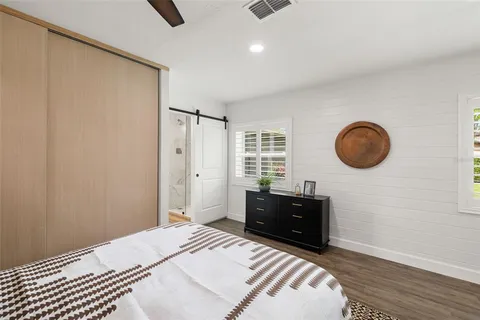 a bedroom with a large bed and a chandelier