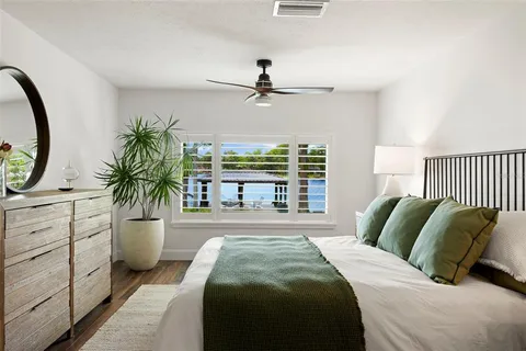 a bedroom with three beds and a window