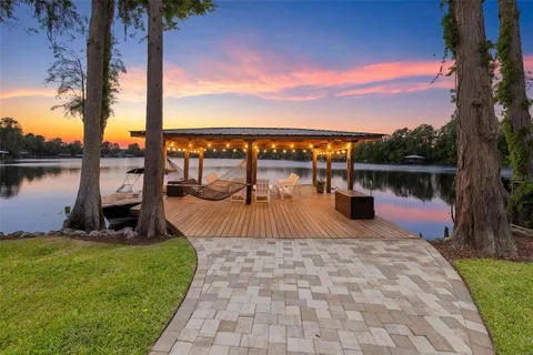 a view of a swimming pool with a patio and a yard