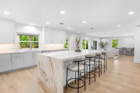 a kitchen with a table and chairs in it