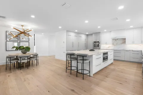 a kitchen with a table and chairs in it
