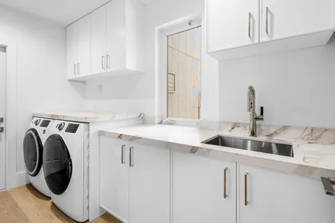 a kitchen with a sink and a washer dryer