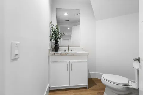 a bathroom with a toilet a sink and mirror