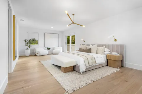 a bedroom with a bed and a chandelier