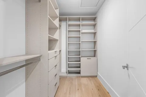 a view of walk in closet with empty racks