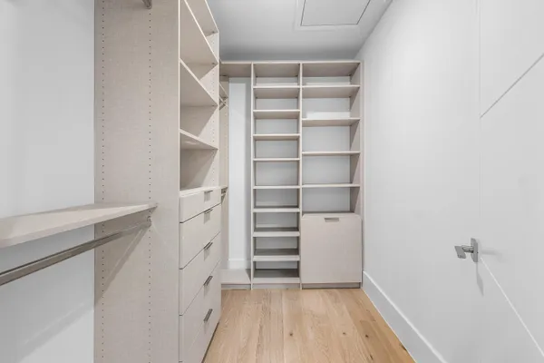 a view of walk in closet with empty racks