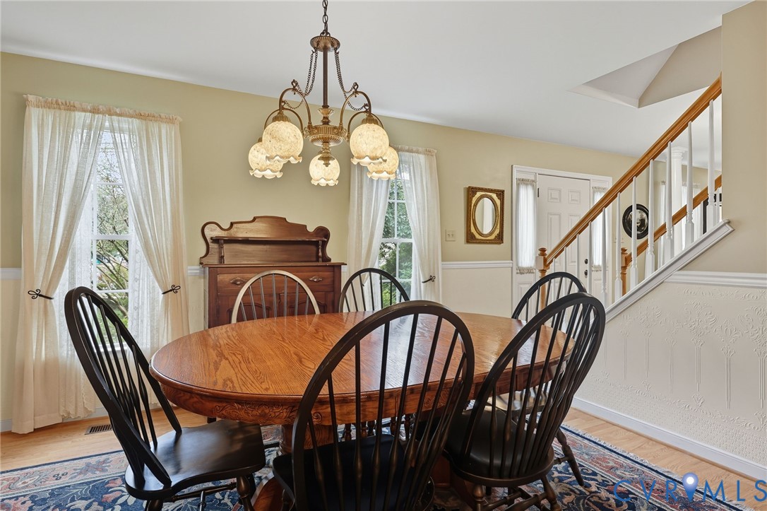 3420 Osborne Road Chester, VA 23831 - Photo 11 of 36 a view of a dining room with furniture wooden floor and chandelier