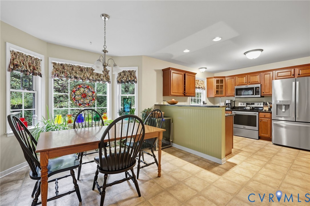 3420 Osborne Road Chester, VA 23831 - Photo 16 of 36 a view of a dining room with furniture large window and stainless steel appliances