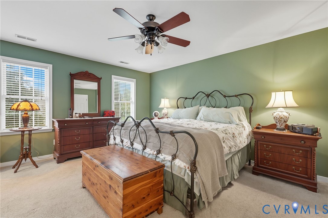 3420 Osborne Road Chester, VA 23831 - Photo 28 of 36 a bedroom with a bed and a chandelier